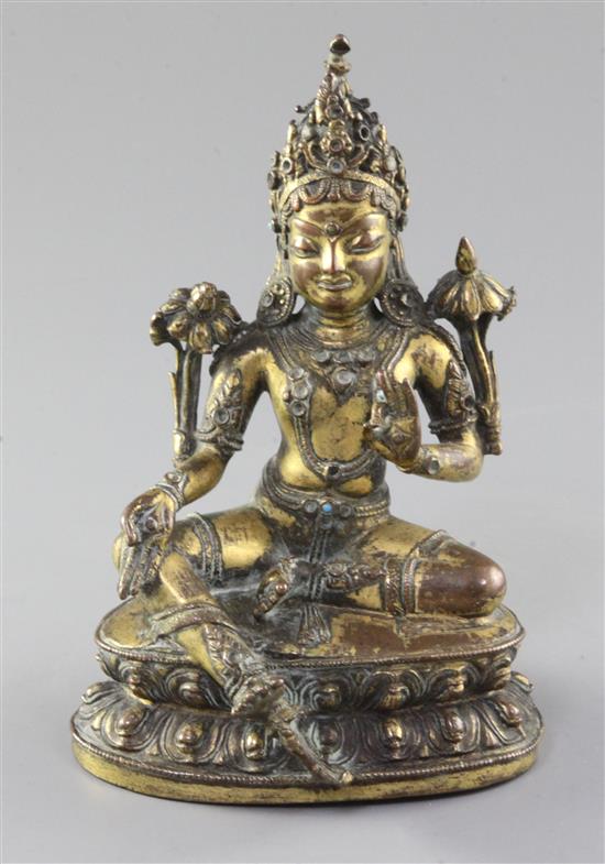 A Tibetan gilt copper alloy seated figure of Green Tara, 17th / 18th century, height 16.5cm